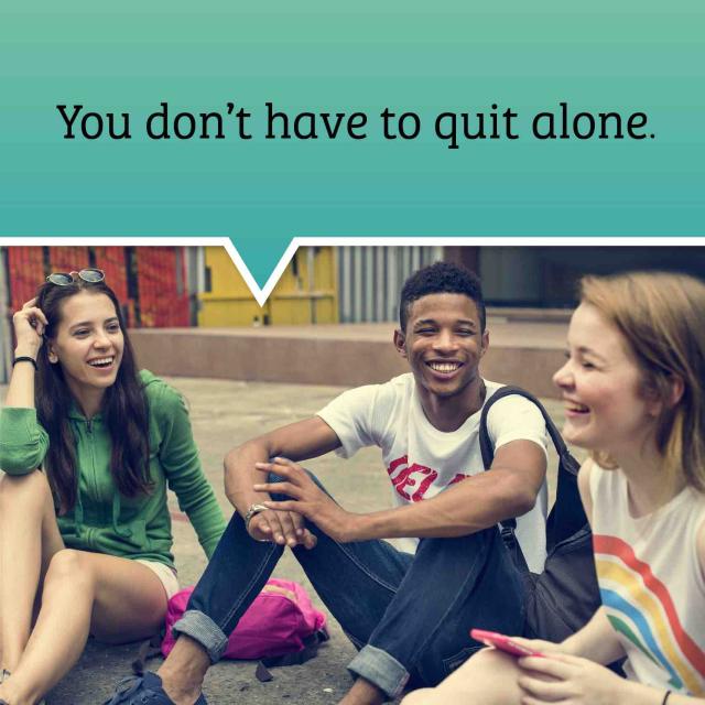 three teens sitting on the ground talking and laughing. Text bubble above their heads saying "you don't have to quit alone".